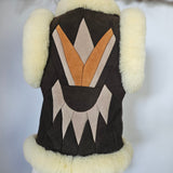 Dog coat with geometric pattern and fur trim on a mannequin against a white background