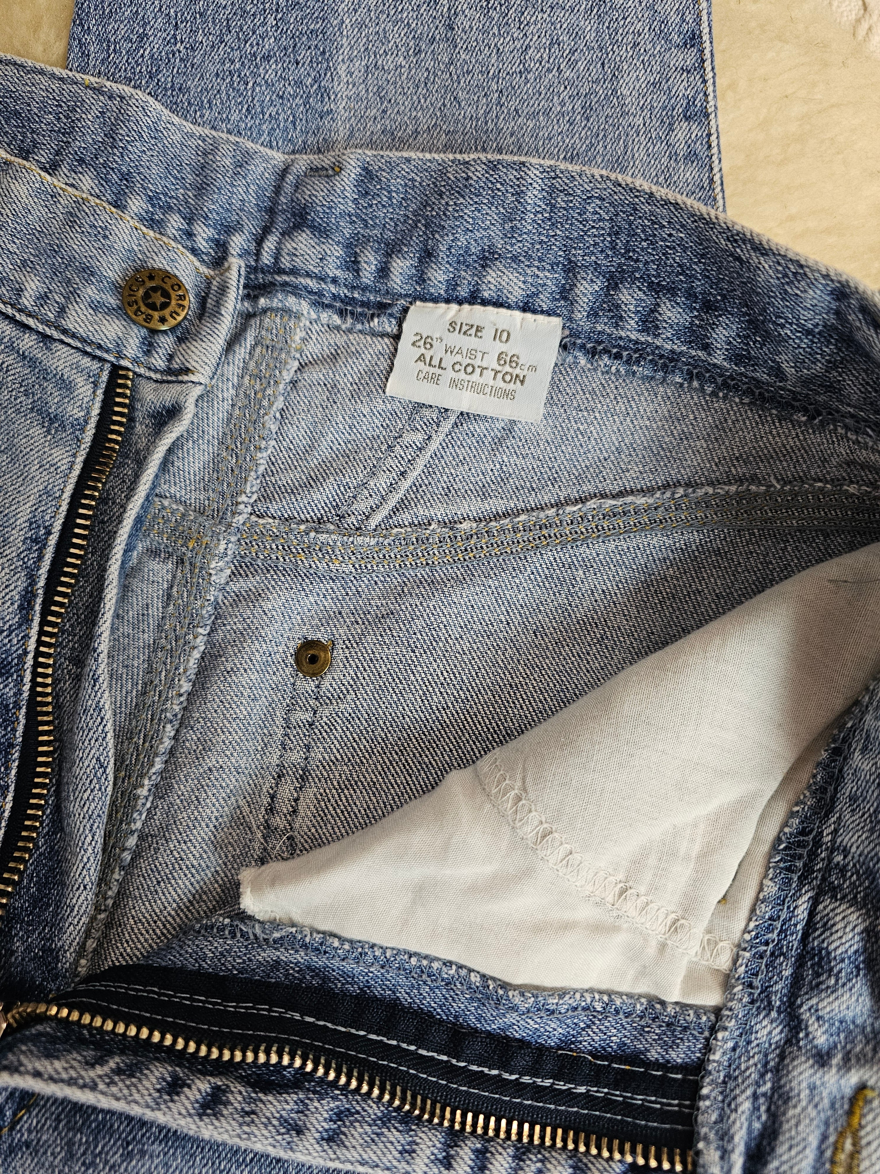 Close-up of a blue denim jacket with a brand label and white lining.