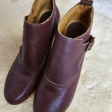 Pair of brown leather shoes on a white textured surface