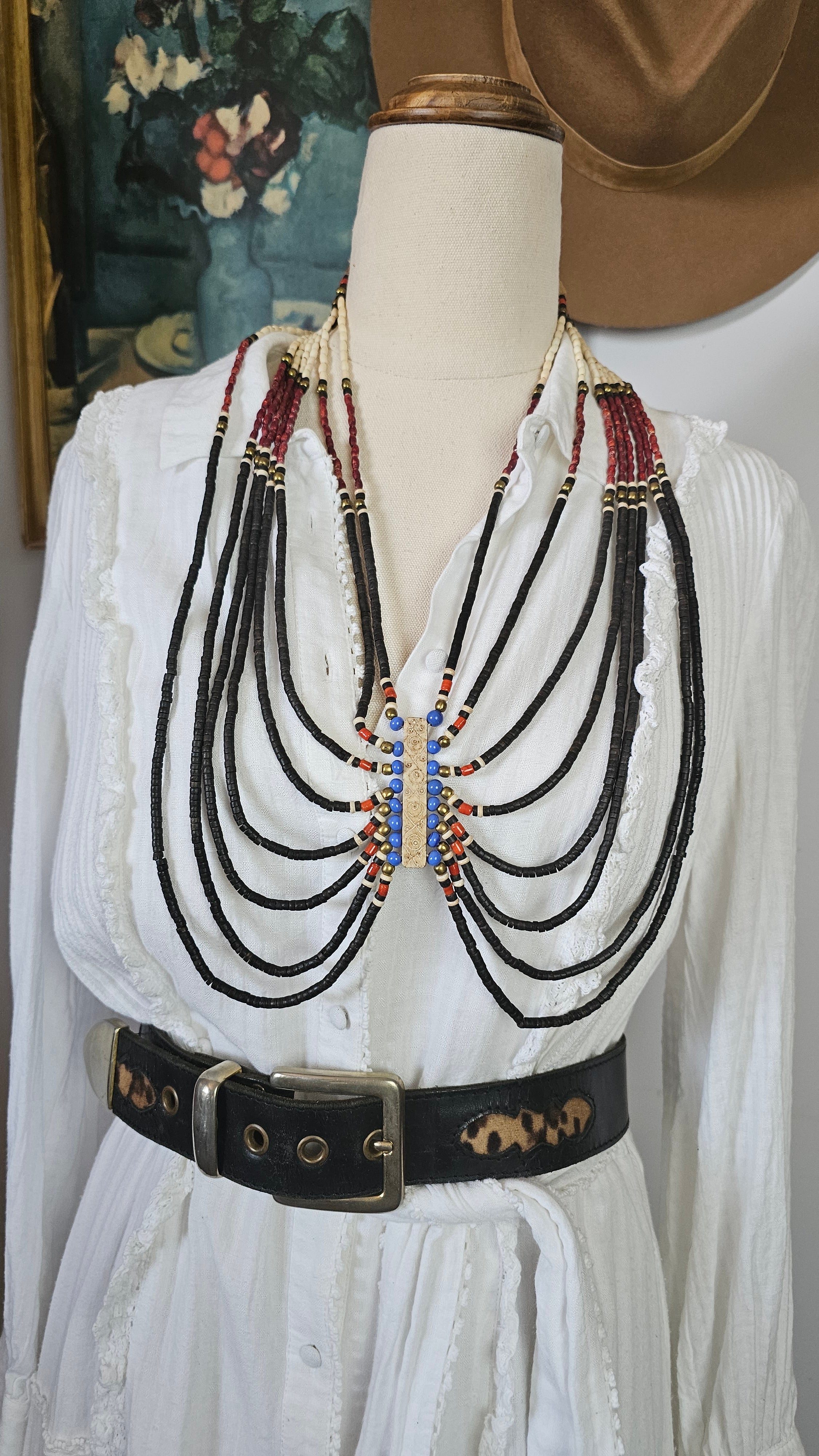 Set of belts displayed on a mannequin with a white background