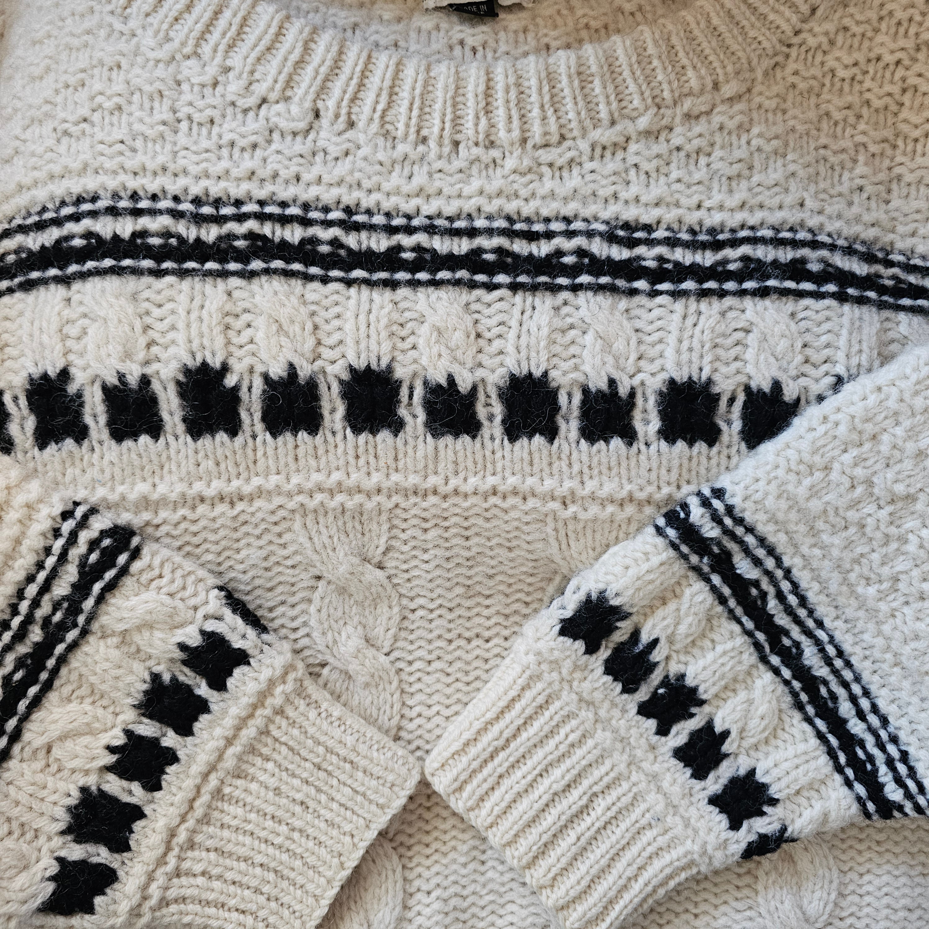 close up of cream cable knit jumper