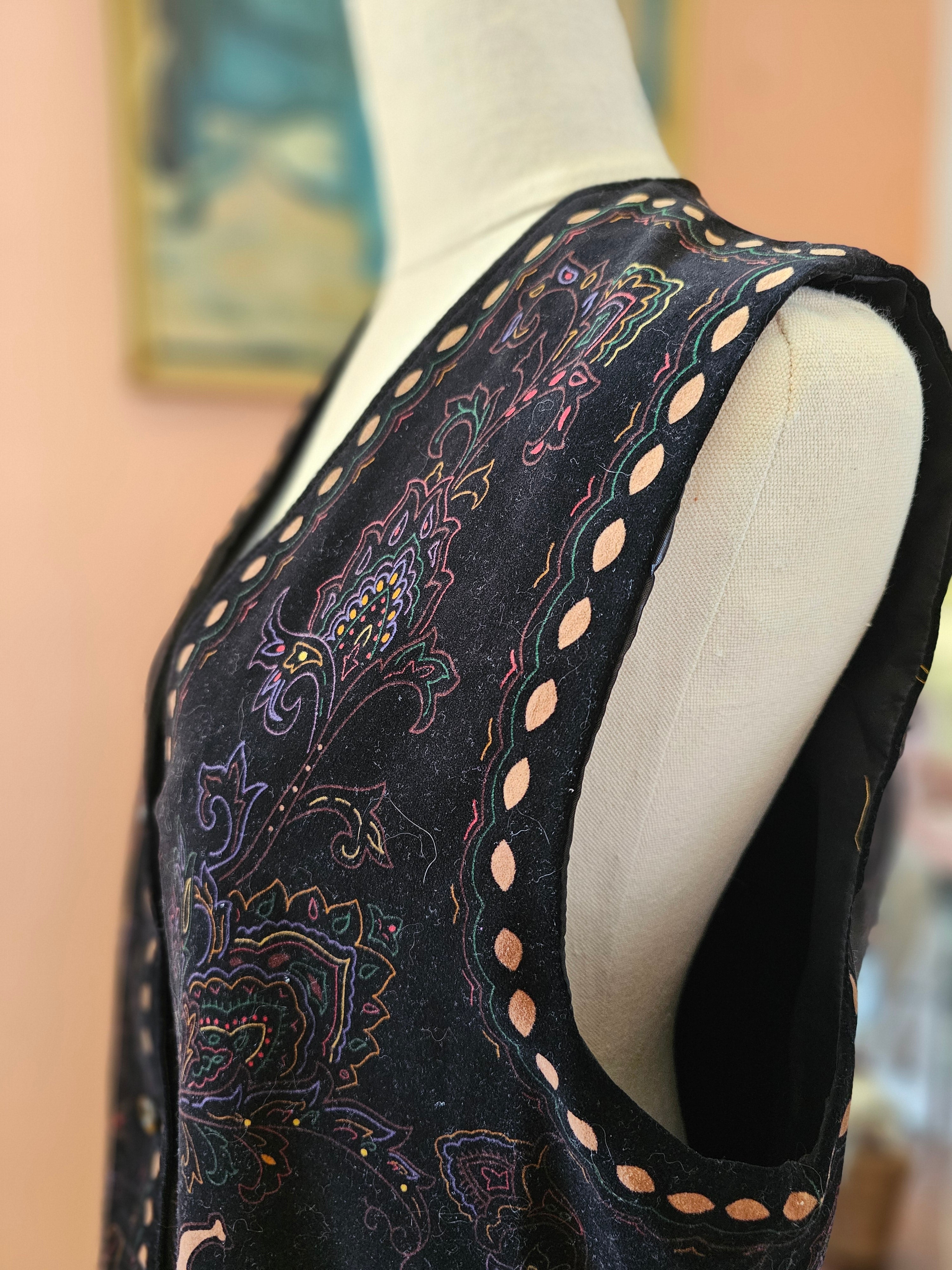 Close-up of a black sandal with intricate patterns on a blurred background