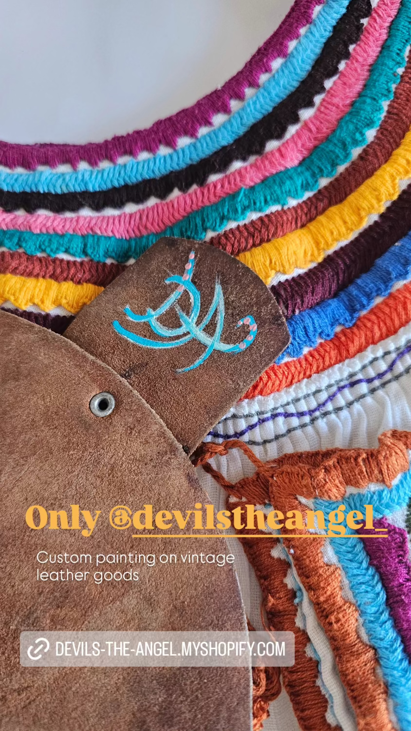 Colorful woven product with a brown leather patch featuring a logo and text.