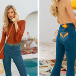 Woman in a stylish outfit with blue jeans and a rust-colored top, standing by a pool.