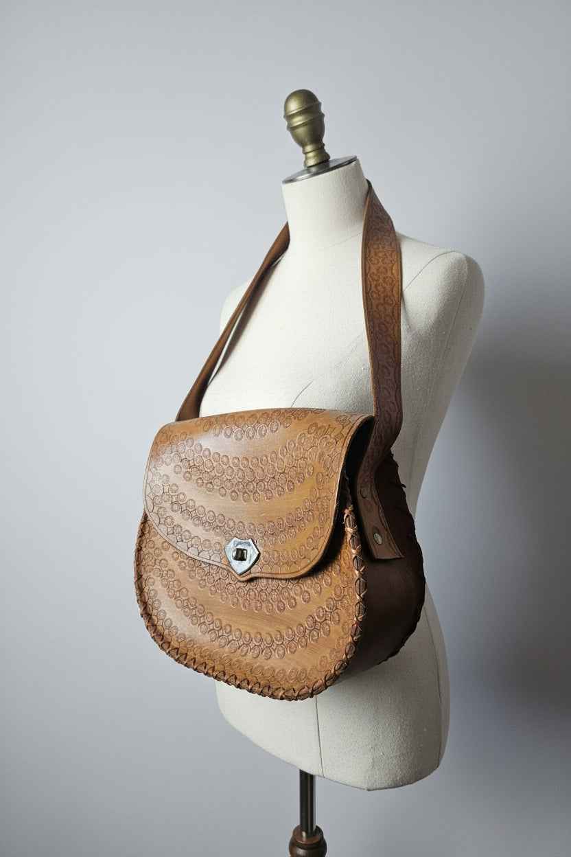 Brown leather saddle with intricate patterns on a vehicle ceiling