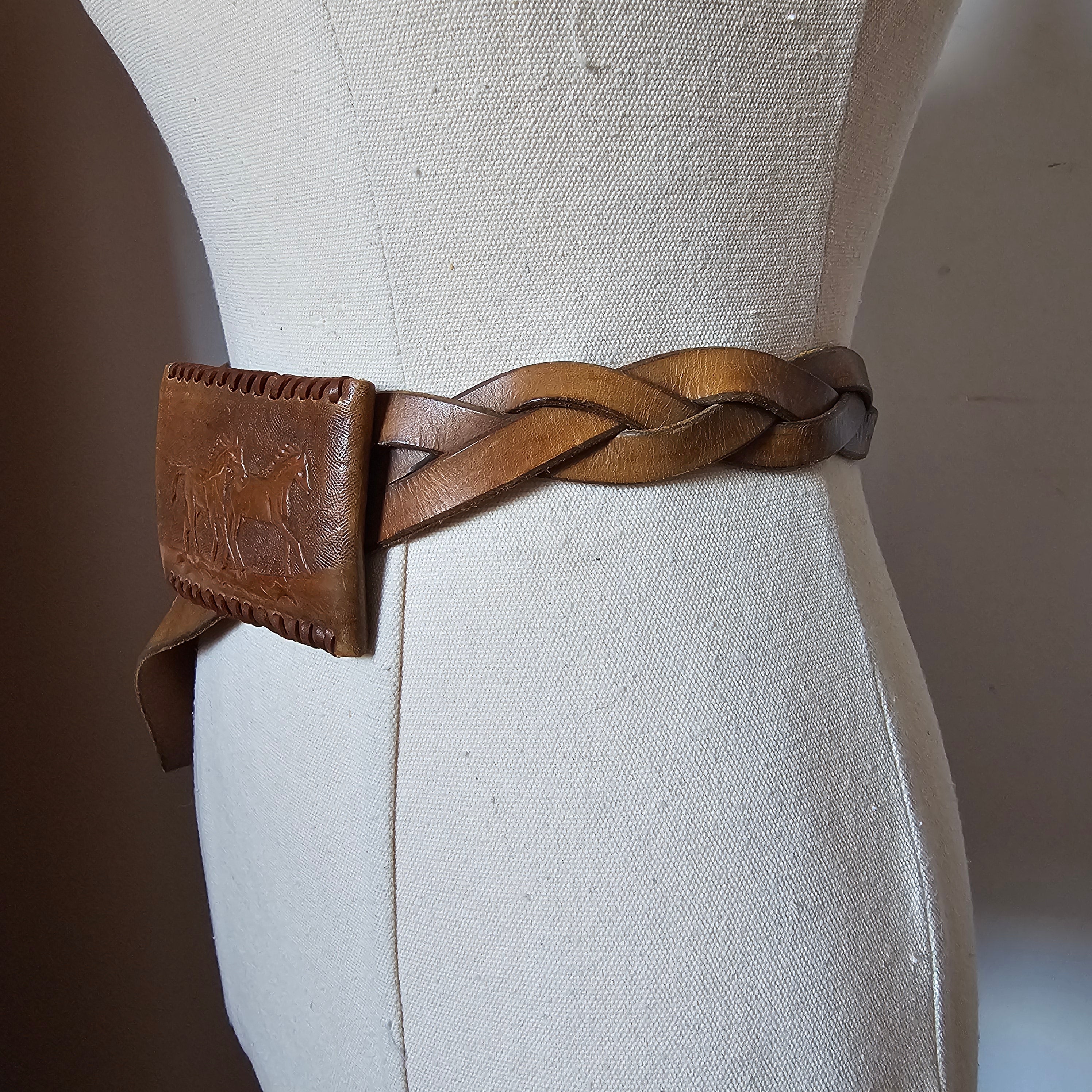 Close-up of a braided leather strap on a beige fabric background