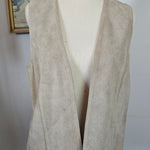 Mannequin wearing a beige trench coat against a plain background