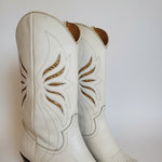 Close-up of white leather with brown floral patterns on a white background