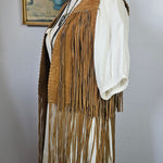 Mannequin wearing a vintage-style dress with a large fan on a plain background