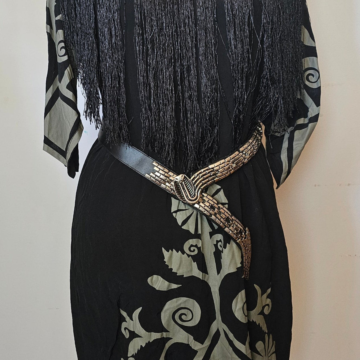 Black fan with intricate design on a white background