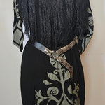 Black fan with intricate design on a white background