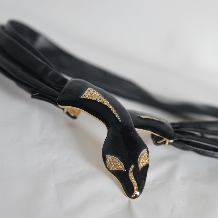 Black umbrella with gold accents on a light gray background