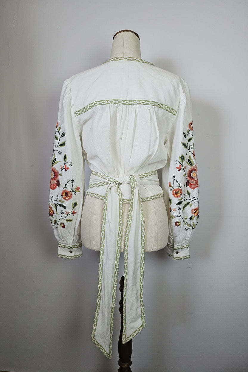 White dress with floral embroidery on a white background