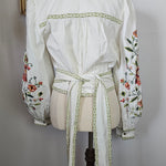 White dress with floral embroidery on a white background