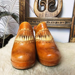 Front view of Vintage Wild Pair Tan Leather Mules – Size 37 showcasing 70s-style stitching and fringe leather accents on the upper.