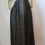 Black pleated skirt on a mannequin against a white background