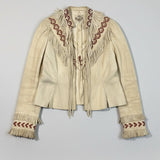 Beige leather jacket with red embroidery and fringes on a polka dot background