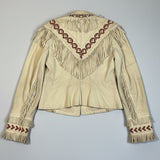 Beige leather jacket with red embroidery and fringes on a polka dot background